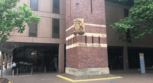 Exterior of the Parramatta Justice Precinct featuring brick architecture and the NSW crest at a courthouse where a Criminal defence lawyer Sydney firm represents clients.