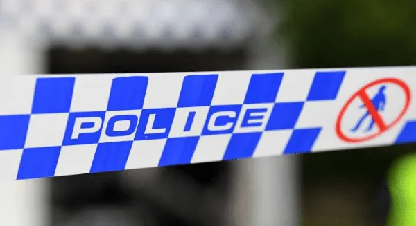 Close-up of blue and white checkered NSW Police tape with a red no-entry symbol, representing a cordoned-off investigation area where a Criminal defence lawyer Sydney firm provides advocacy.