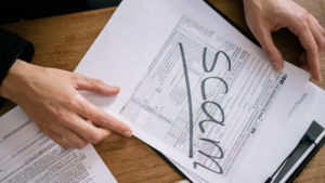 Tax return form marked "SCAM" highlighting fraud lawyer Sydney advice